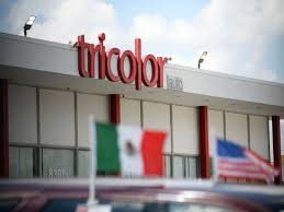 A building with a sign and flags
AI-generated content may be incorrect.